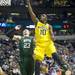 Michigan sophomore Tim Hardaway Jr. shoots the ball around Ohio University junior Ivo Baltic in the first half of the second round of the NCAA tournament at Bridgestone Arena in Nashville, Tenn.  Melanie Maxwell I AnnArbor.com